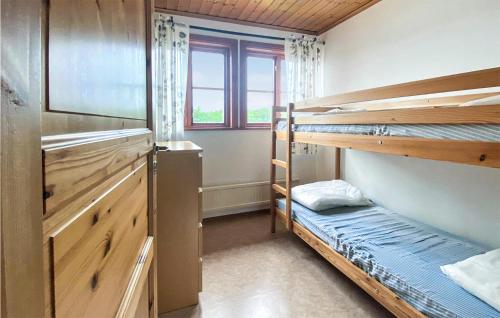a bedroom with two bunk beds and a window at Amazing Home In Örkelljunga With Sauna in Orkelljunga