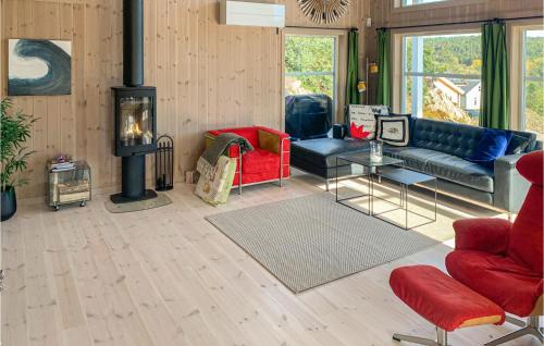 a living room with a couch and a fireplace at Beautiful Home In Risør With Kitchen in Risør