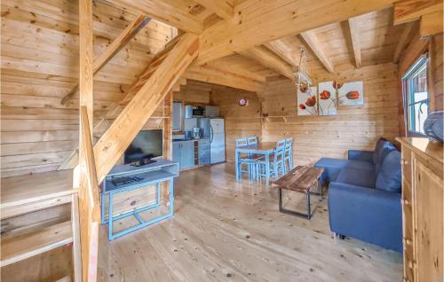 a living room and kitchen in a log cabin at Cozy Home In Mscice With Kitchen in Mścice