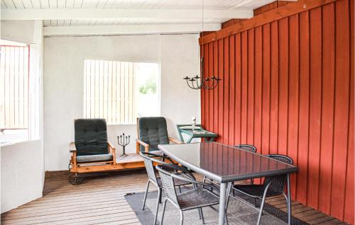 a dining room with a table and two chairs at Two-Bedroom Holiday Home In Rorvik in Rörvik