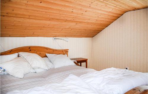 a large bed in a room with a wooden ceiling at Two-Bedroom Holiday Home In Rorvik in Rörvik