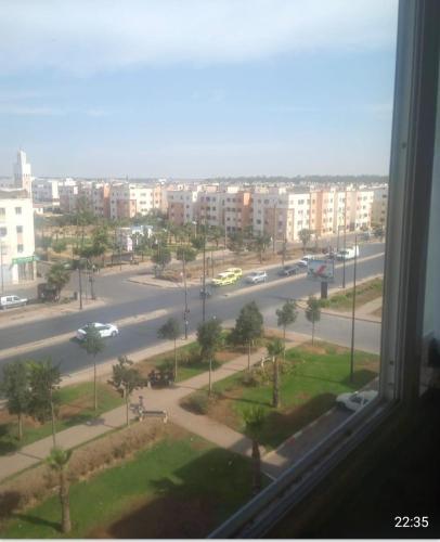 a view of a city street from a window at Adorable Apartamento a 8 Min del Aeropuerto de Casablanca,WiFi Ultra Rapido y Parking Gratis in Derroua