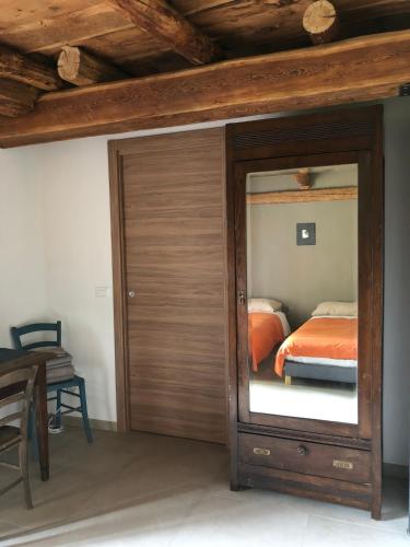 a bedroom with a sliding glass door with a bed at Cicapuy in Puys
