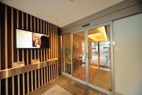 a hallway with black and white striped walls at Dormy Inn Express Meguro Aobadai Hot Spring in Tokyo