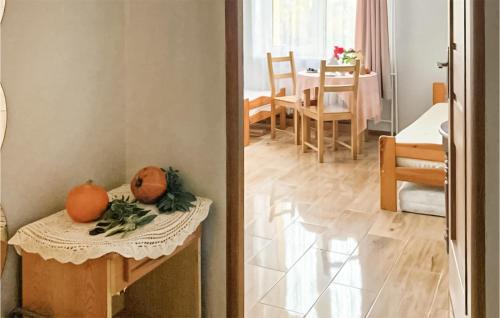 two oranges sitting on a table in a room at Beautiful Apartment In Zielona Góra in Zielona Góra