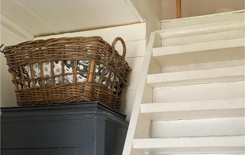a wicker basket sitting on the side of a stairs at 3 Bedroom Awesome Home In Vallda in Vallda
