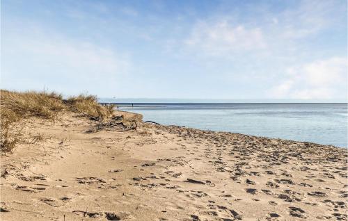a sandy beach with the ocean in the background at Lovely Home In Heberg With Sauna in Heberg