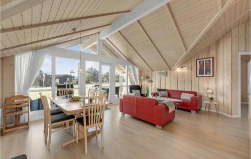 a living room with a red couch and a table at Amazing Home In Skjern With Kitchen in Halby