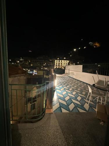 a balcony with a view of a city at night at Palazzo Colavolpe Suite in Atrani