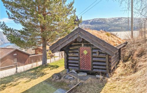 a small log cabin with a grass roof at Lovely Home In Rysstad in Rysstad