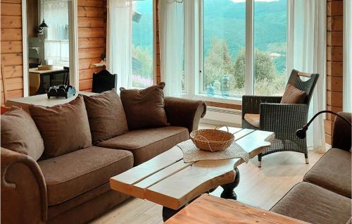 a living room with a couch and a table at Lovely Home In Rysstad in Rysstad