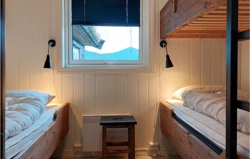 a bedroom with two bunk beds and a window at Lovely Home In Rysstad in Rysstad