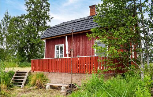 a red house with a red fence around it at 2 Bedroom Gorgeous Home In Bottnaryd in Bottnaryd