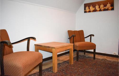 a waiting room with two chairs and a table at Awesome Home In Vittsjö in Vittsjö