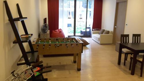 a living room with a foosball table in the middle at Baan Mai Khao Beach Residence in Mai Khao Beach