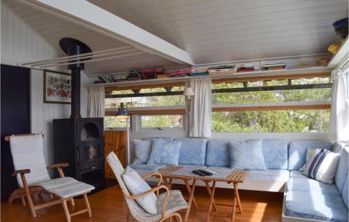 a living room with a blue couch and a table at Four-Bedroom Holiday Home In Tvedestrand in Tvedestrand