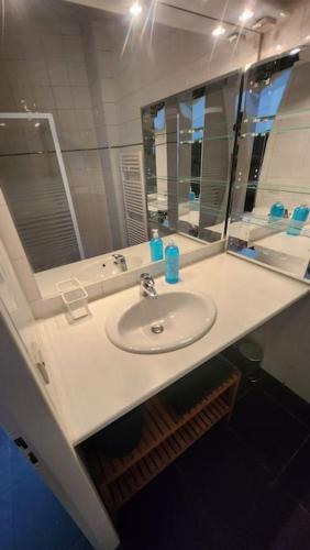 une salle de bain avec un lavabo blanc et un miroir dans l'établissement T3 moderne hyper centre parking privé, à Toulouse