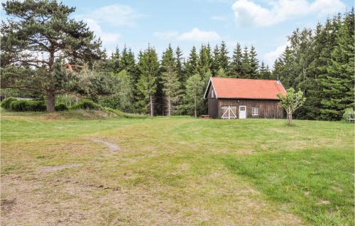 an open field with a barn in the background at 3 Bedroom Awesome Home In Årjäng in Årjäng