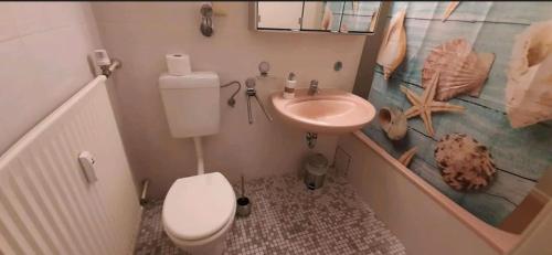 a small bathroom with a toilet and a sink at Perfect Place to be in Hannover