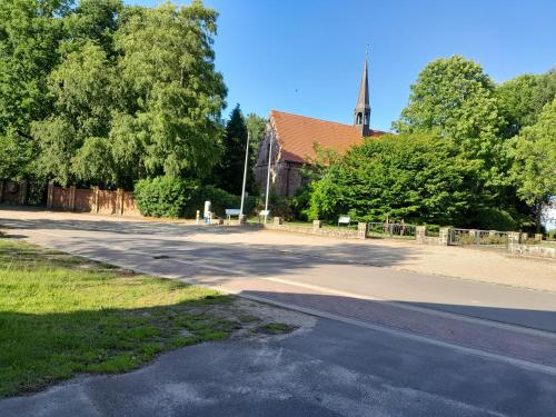an empty road in front of a church at Landgasthaus Sankt Annen in Sankt Annen