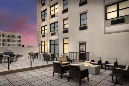 a patio with tables and chairs on a building at Residence Inn New Rochelle in New Rochelle