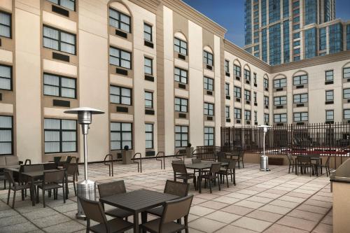 a patio with tables and chairs in front of a building at Residence Inn New Rochelle in New Rochelle