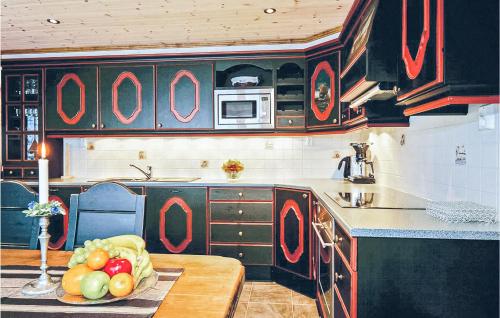 a kitchen with a table with a bowl of fruit on it at Skarsnuten in Hemsedal
