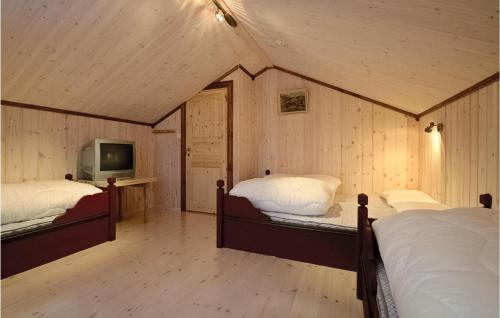 a room with two beds and a tv in it at Skarsnuten in Hemsedal
