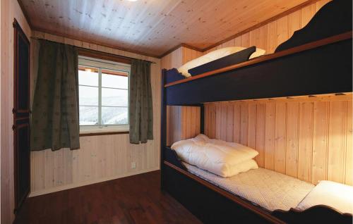 a bunk bed in a room with a window at Skarsnuten in Hemsedal