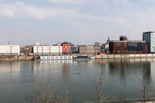 a view of a city with a river and buildings at Moxy Ludwigshafen in Ludwigshafen am Rhein