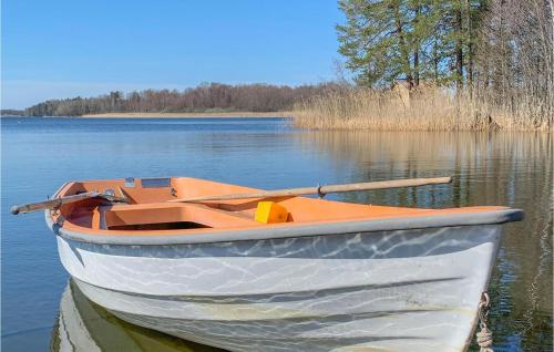 a boat sitting in the water on a lake at Awesome Home In Vrena With Wifi in Vrena