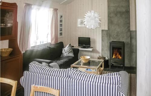 a living room with a couch and a fireplace at Holiday Home Gålå Peer Gyntlia Iv in Gålå