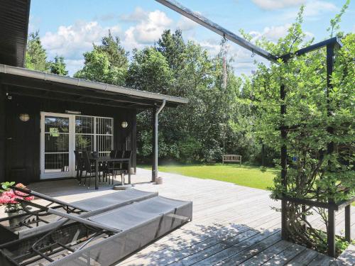 a screened in porch of a house with a patio at 4 star holiday home in Hals-By Traum in Hals