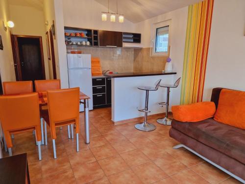 a kitchen and living room with a couch and a table at Vila Natalia in Petrovac na Moru