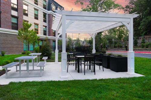 a white pavilion with tables and chairs in a park at Fairfield by Marriott Inn & Suites Annapolis in Annapolis
