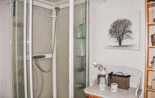 a bathroom with a shower with a tree on the wall at 3 Bedroom Gorgeous Home In Tobyn in Tobyn
