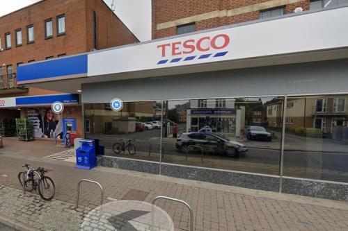a tesco store with a bike parked outside of it at Stylish 3-Bedroom House with Garden & Free Parking's, Prime location with private garden in Kidlington