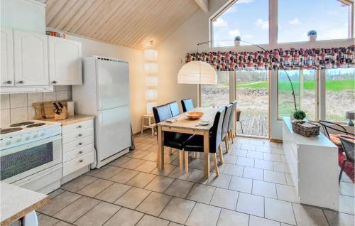 a kitchen with a table and a dining room at Stunning Home In Bolmsö With Wifi in Bolmsö