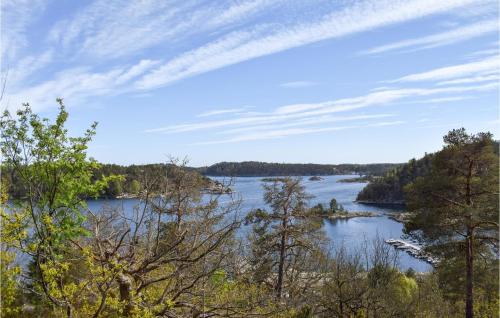 a view of a river with trees in the foreground at Three-Bedroom Holiday Home In Tvedestrand in Tvedestrand