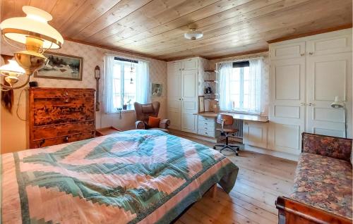 a bedroom with a bed and a desk and a chair at Nice Home In Markaryd With Wifi in Markaryd