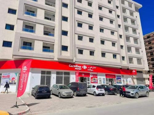 a car dealership with cars parked in front of a building at Happy Sweet Inn in Irbid