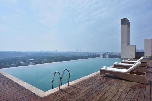 a swimming pool on the roof of a building at Four Points by Sheraton Kochi Infopark in Cochin