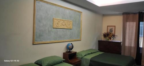 a room with two beds and a picture on the wall at La casa di nonna Lia in Tollo