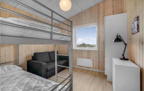 a bedroom with a bunk bed and a chair at Beautiful Home In Løgstrup With Kitchen in Løgstrup