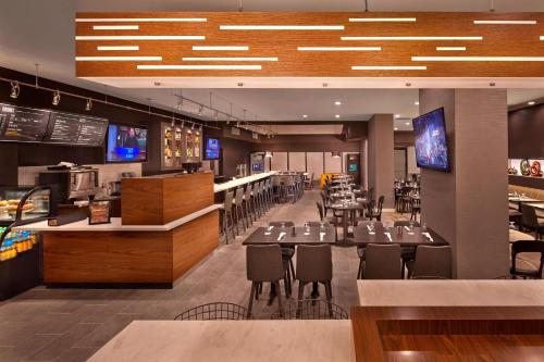 a restaurant with tables and chairs and a bar at Courtyard by Marriott Philadelphia City Avenue in Philadelphia