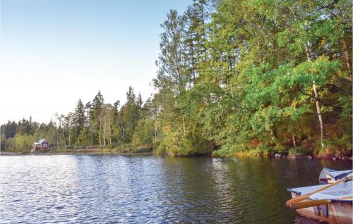 a lake with a house in the middle of it at One-Bedroom Holiday Home In Vittsjo in Vittsjö