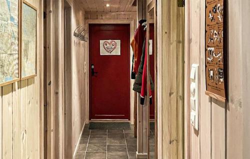 a hallway with a red door with a sign on it at Awesome Home In Rauland With Kitchen in Rauland