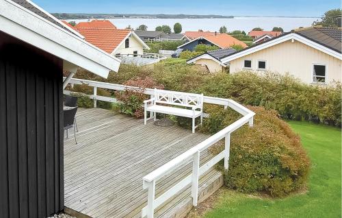 a wooden deck with a bench on top of a house at Holiday Home Hvedemarken Vi in Hejls