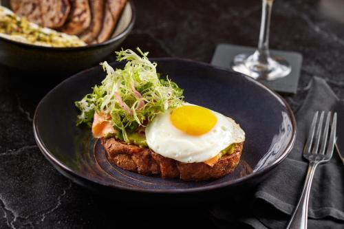 a plate with an egg on top of a piece of bread at The Ritz-Carlton Georgetown, Washington, D.C. in Washington