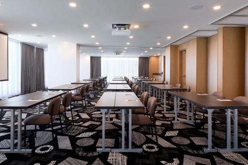 a row of tables and chairs in a room at Courtyard by Marriott Montreal Laval in Laval
